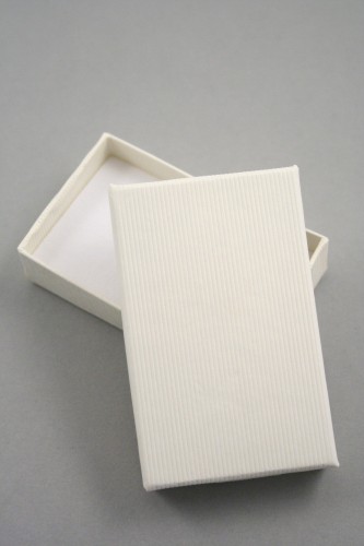 Lined Textured Cream Gift Box with White Flock Insert with two corner slits for a chain and two 2 cm centre slits. Size 8cm x 5cm x 2.2cm.
