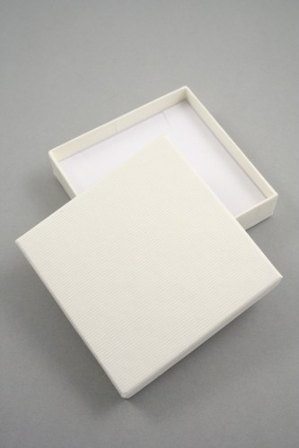 Lined Textured Cream Gift Box with White Flock Insert with two corner slits for a chain and a centre 40mm slit. Size 9cm x 9cm x 2.2cm.