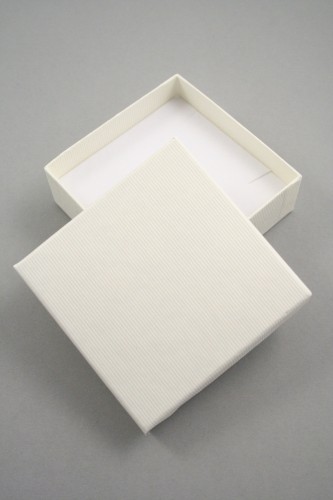 Lined Textured Cream Gift Box with White Flock Insert with two corner slits for a chain and a centre 40mm slit. Size 9cm x 9cm x 3cm.