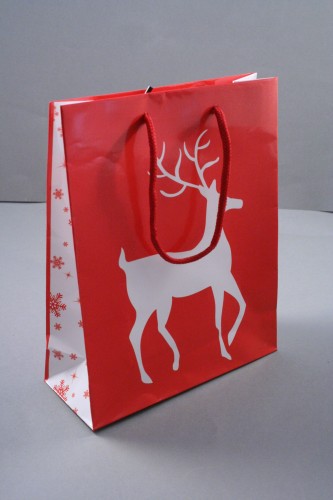 Glossy Red Christmas Gift Bag with White Reindeer Design. Red Corded Handles. Size Approx 22cm x 18cm x 7cm.