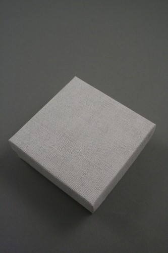 Cream Linen Effect Gift Box with Black Flocked Inner. Approx Size: 9cm x 9cm x 3cm.