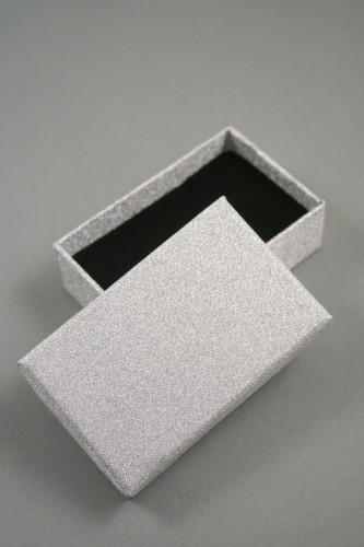 Silver Glitter Gift Box. Size Approx 8cm x 5cm x 2.5cm. This box has a black flocked foam pad insert with two corner slits for a chain and two 2cm centre slits