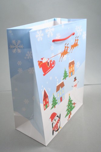 Christmas Scene Glossy Gift Bag with Blue Background and Red Cord Handles. Approx Size 23cm x 18cm x 9cm