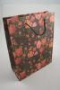 Black Floral Printed Kraft Paper Gift Bag with Black Corded Handles. Size Approx 24cm x 19cm x 8cm. - view 2